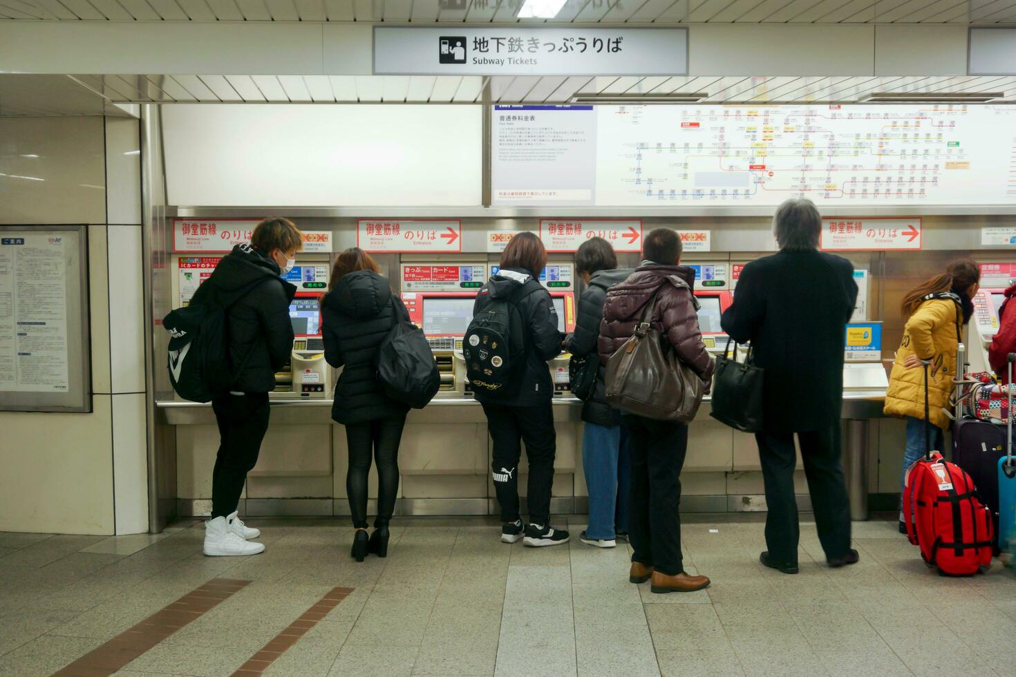 Sapporo City, Japan, 2018 - Group of peoples and tourists purchasing subway tickets through automated ticket machines at subway station. photo