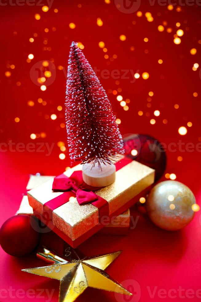 christmas tree and gifts on bright red background photo