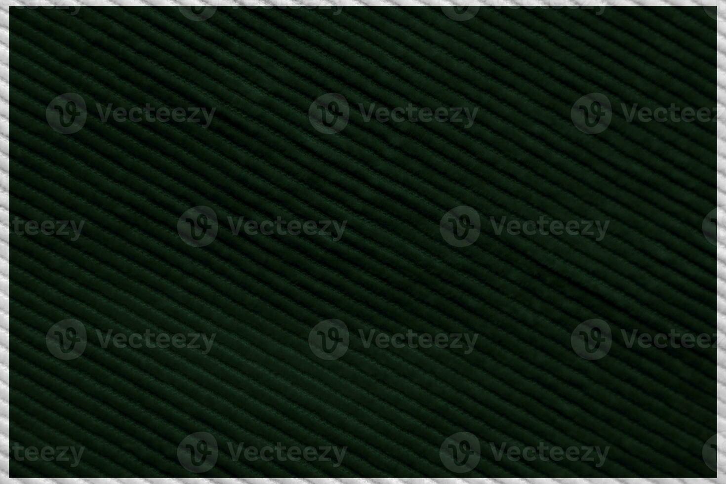 dark green corduroy fabric texture used as background. Emerald color panne fabric background of soft and smooth textile material. cloth, velvet, grooves luxury green tone for silk. photo