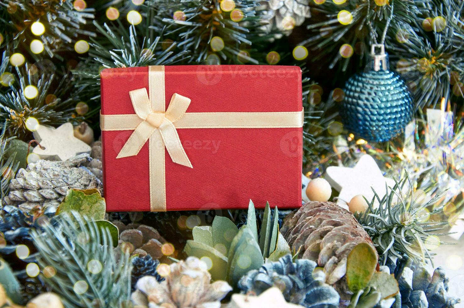 Christmas composition with Christmas tree branches, red tinsel, gift boxes and silver tinsel photo