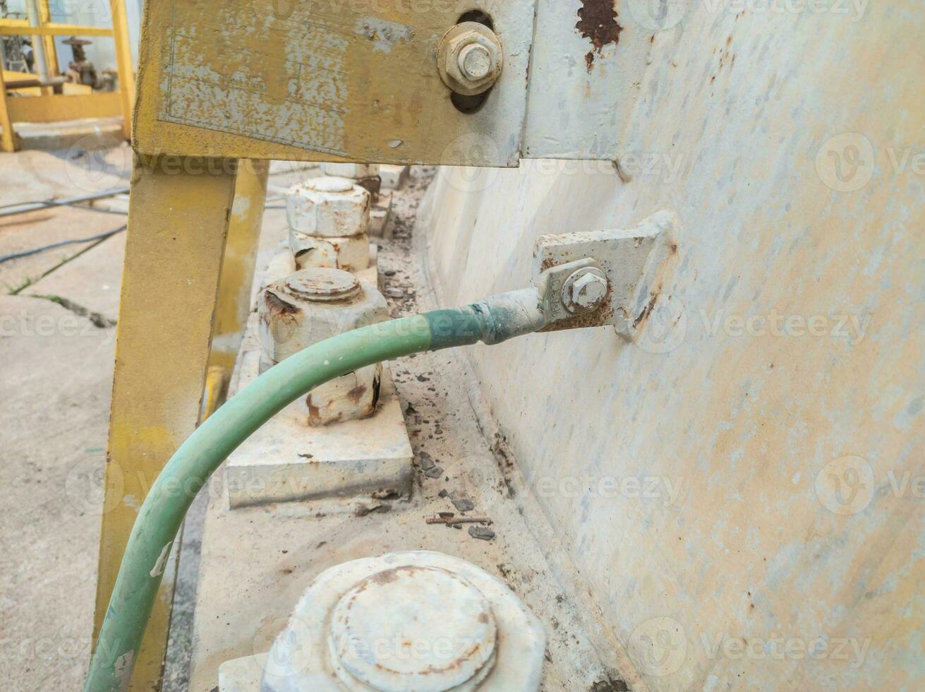 grounding electrical cables and copper rods planted in the ground function to ward off lightning in tall buildings and short circuits photo