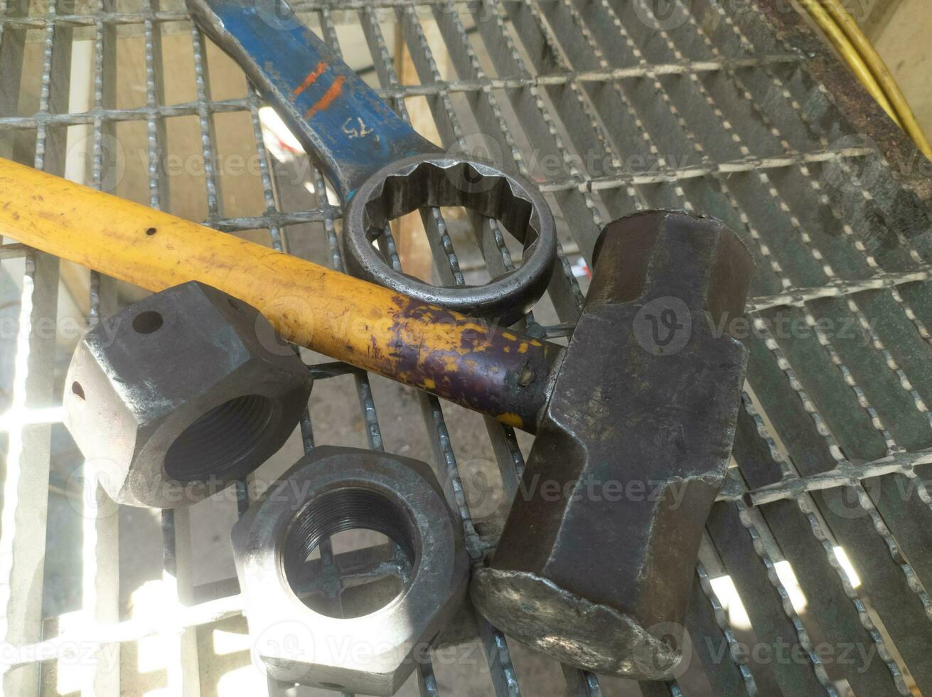 sledgehammer and ring wrench used to open large, hard bolts photo