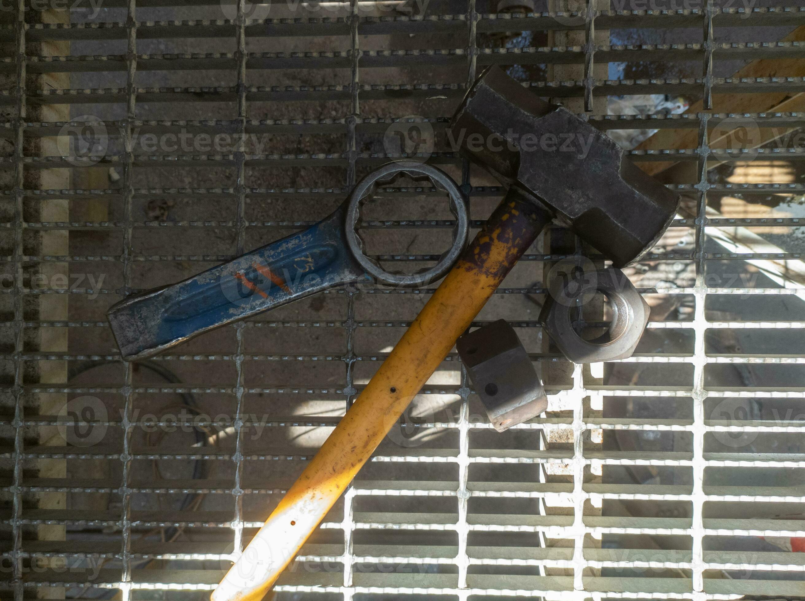 sledgehammer and ring wrench used to open large, hard bolts 35329617