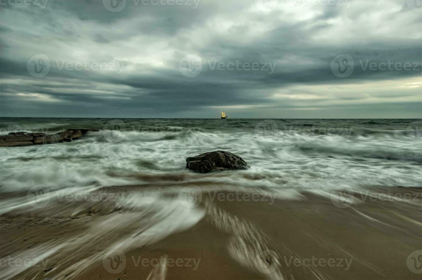 Beauty cloudy, long exposure seascape with slow shutter and waves flowing out. photo