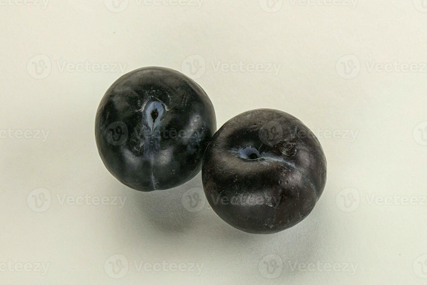 Two ripe sweet black plums photo