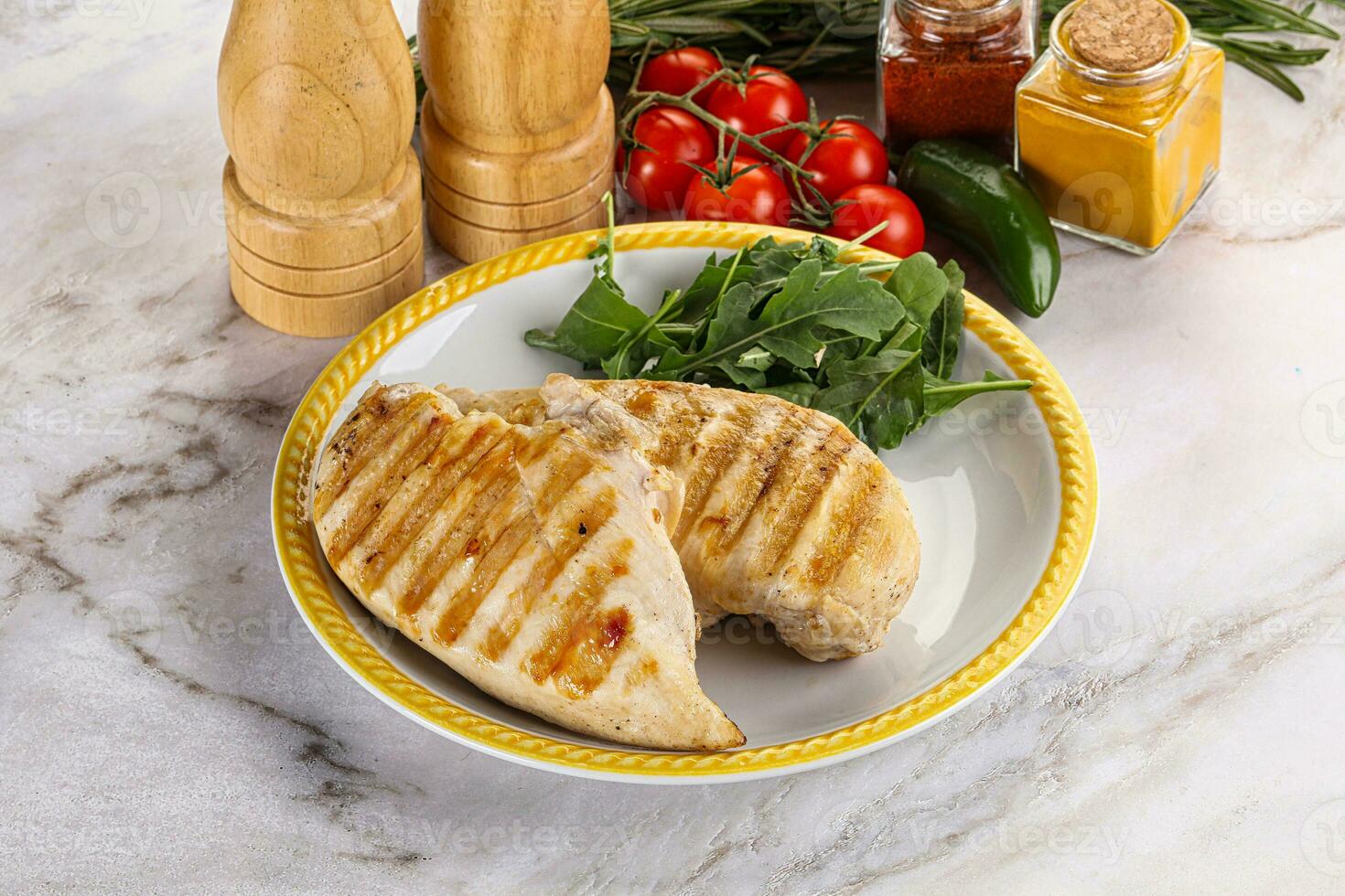 Grilled chicken breast served arugula photo