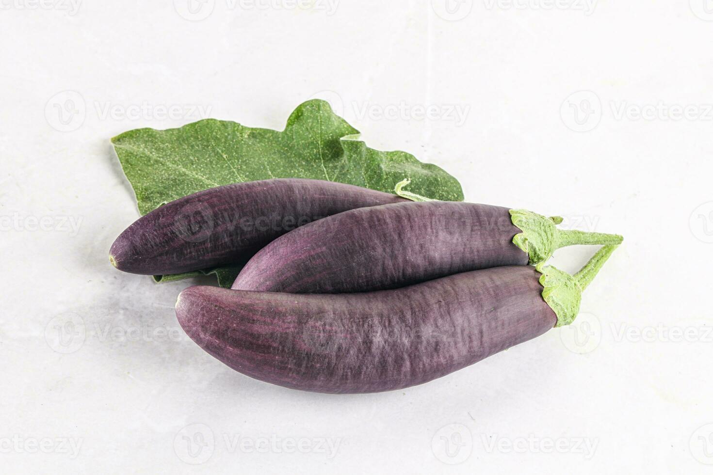 Raw ripe organic eggplant with leaf photo