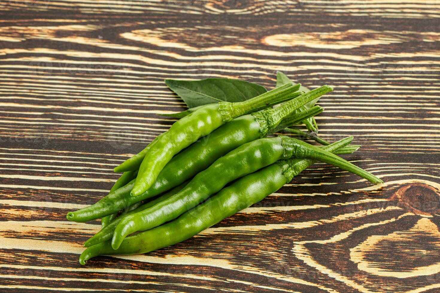 Spicy green chili pepper heap photo