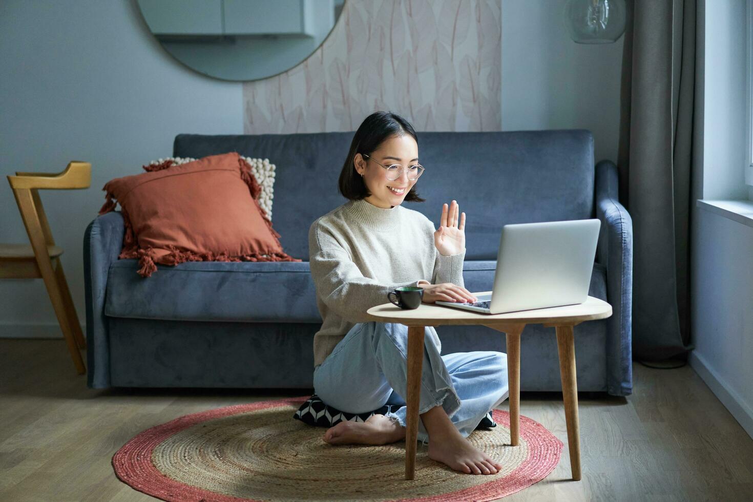 Portrait of young working woman, korean girl studying on remote online, talking to laptop, video chat, has conversation via computer application photo
