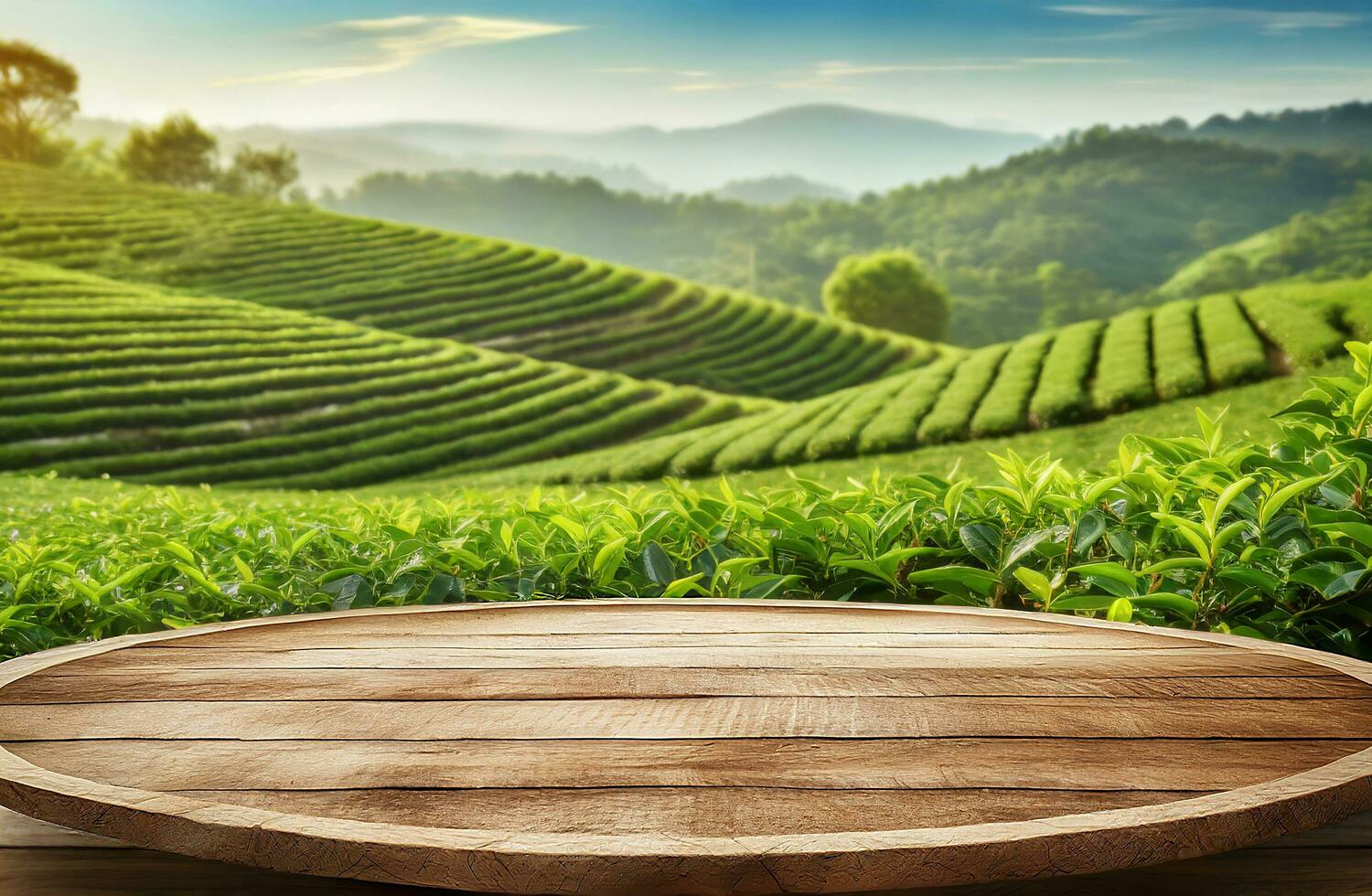 Circle wooden table top with blurred tea plantation landscape against blue sky and blurred green leaf frame Product display concept natural background photo