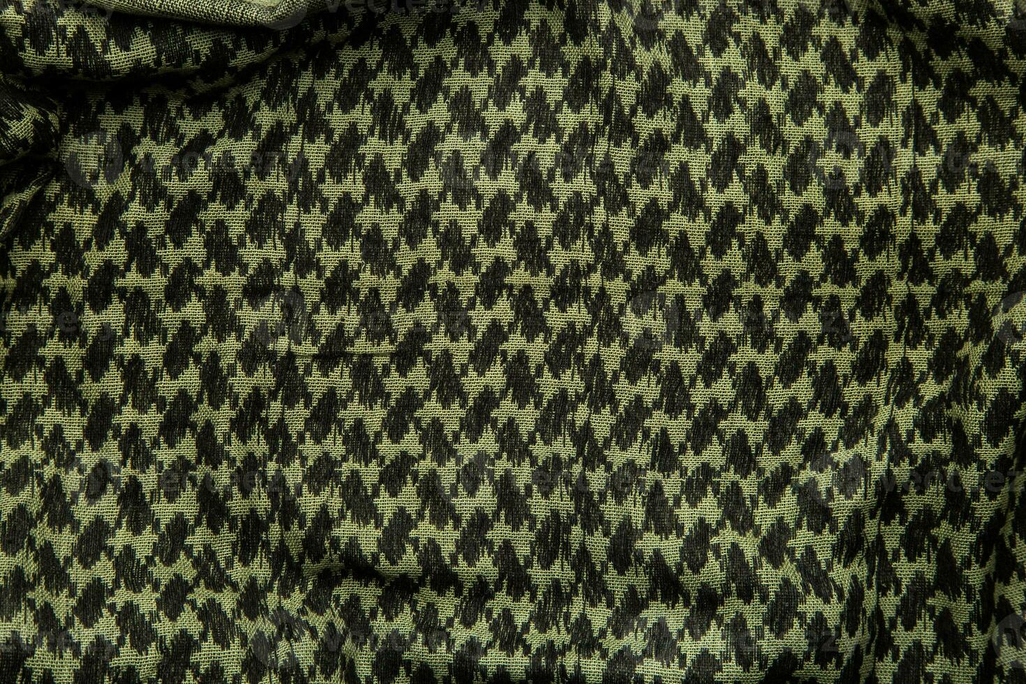 Keffieh scarf. The texture of the cotton traditional symbolic arabian scarf. Khaki back. photo