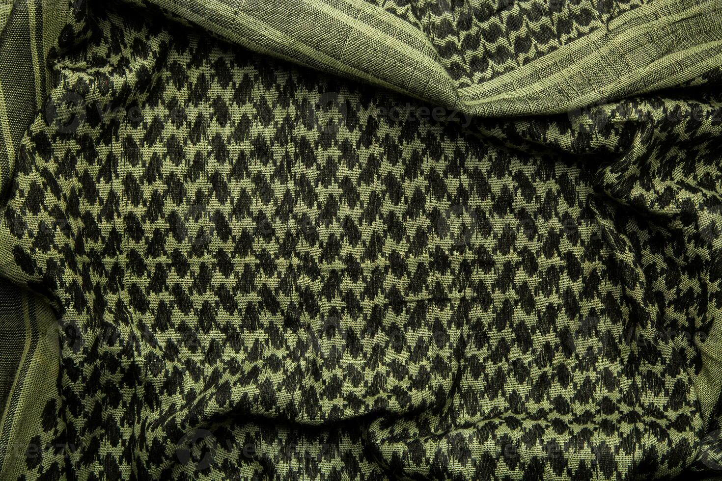Keffieh scarf. The texture of the cotton traditional symbolic arabian scarf. Khaki back. photo
