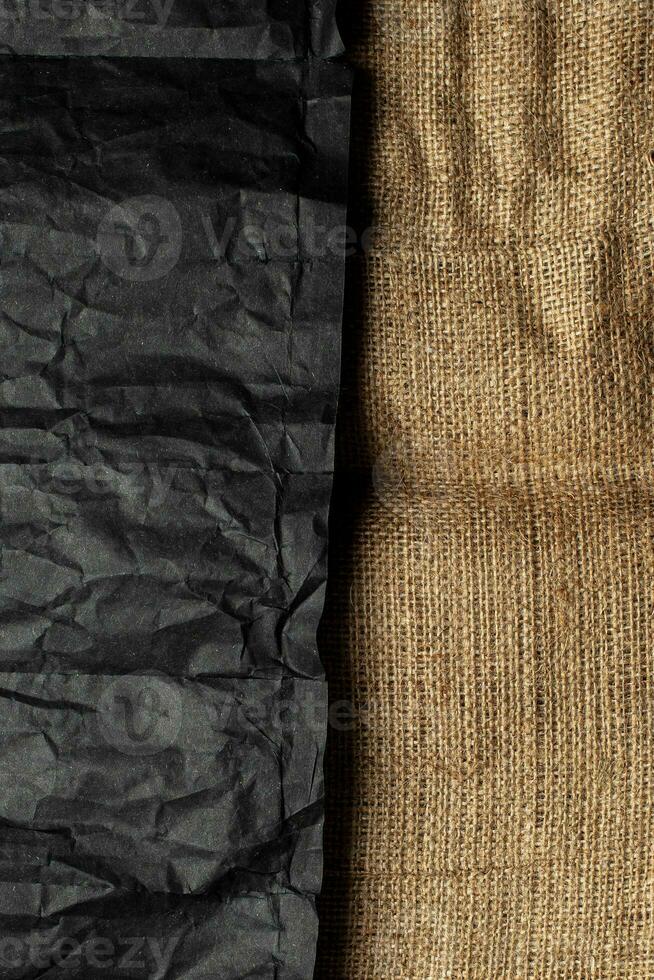 Burlap fabric texture and black crumpled paper. Rough vintage back photo