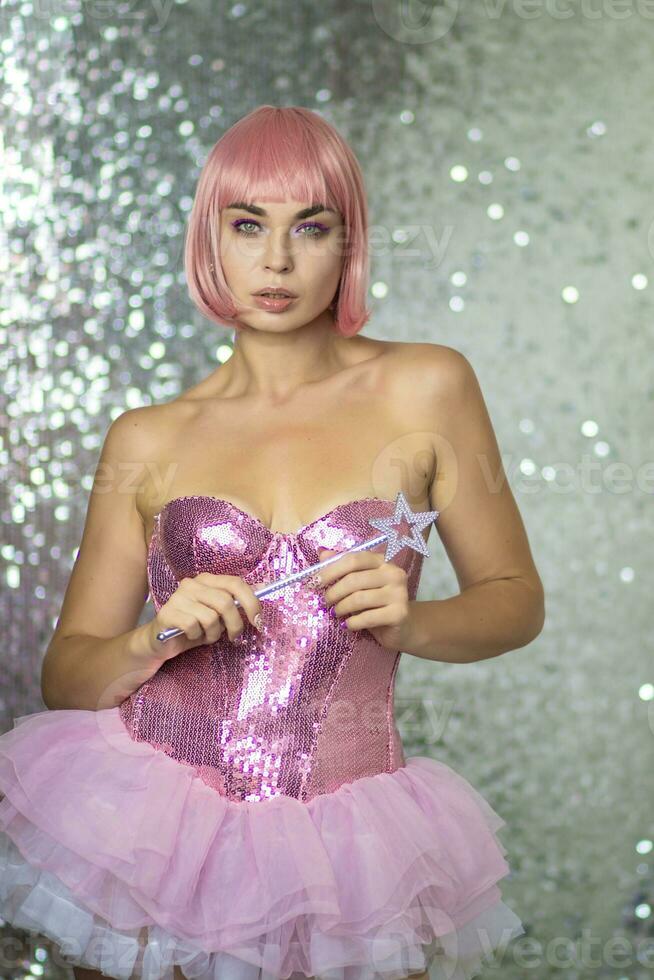 Woman in a short pink wig with a magic wand photo