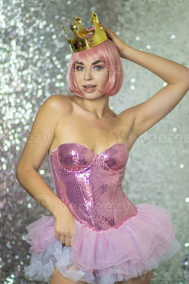 Woman in pink wig with gold crown. Halloween photo