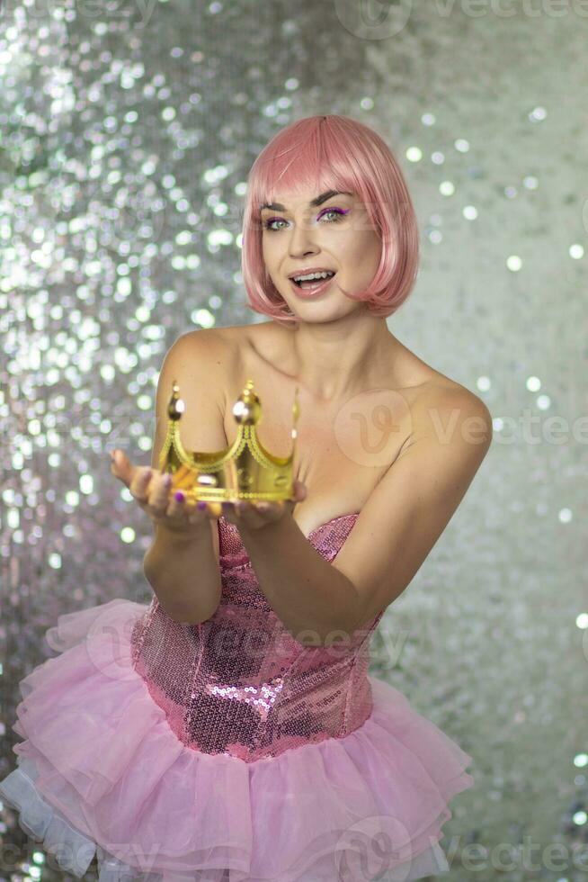 Woman in pink wig with gold crown. Halloween photo