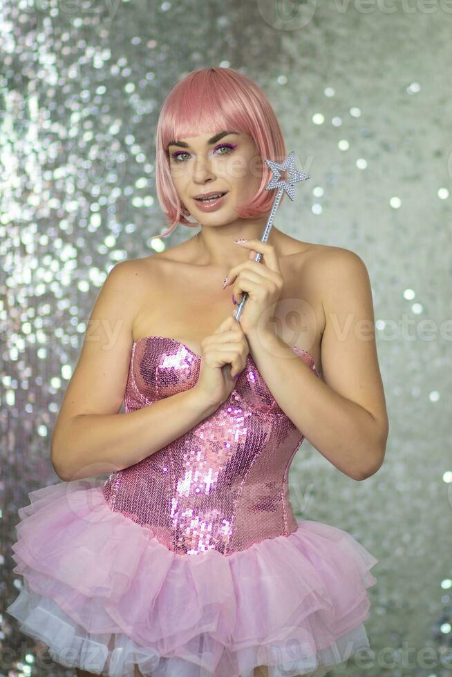 Woman in a short pink wig with a magic wand photo