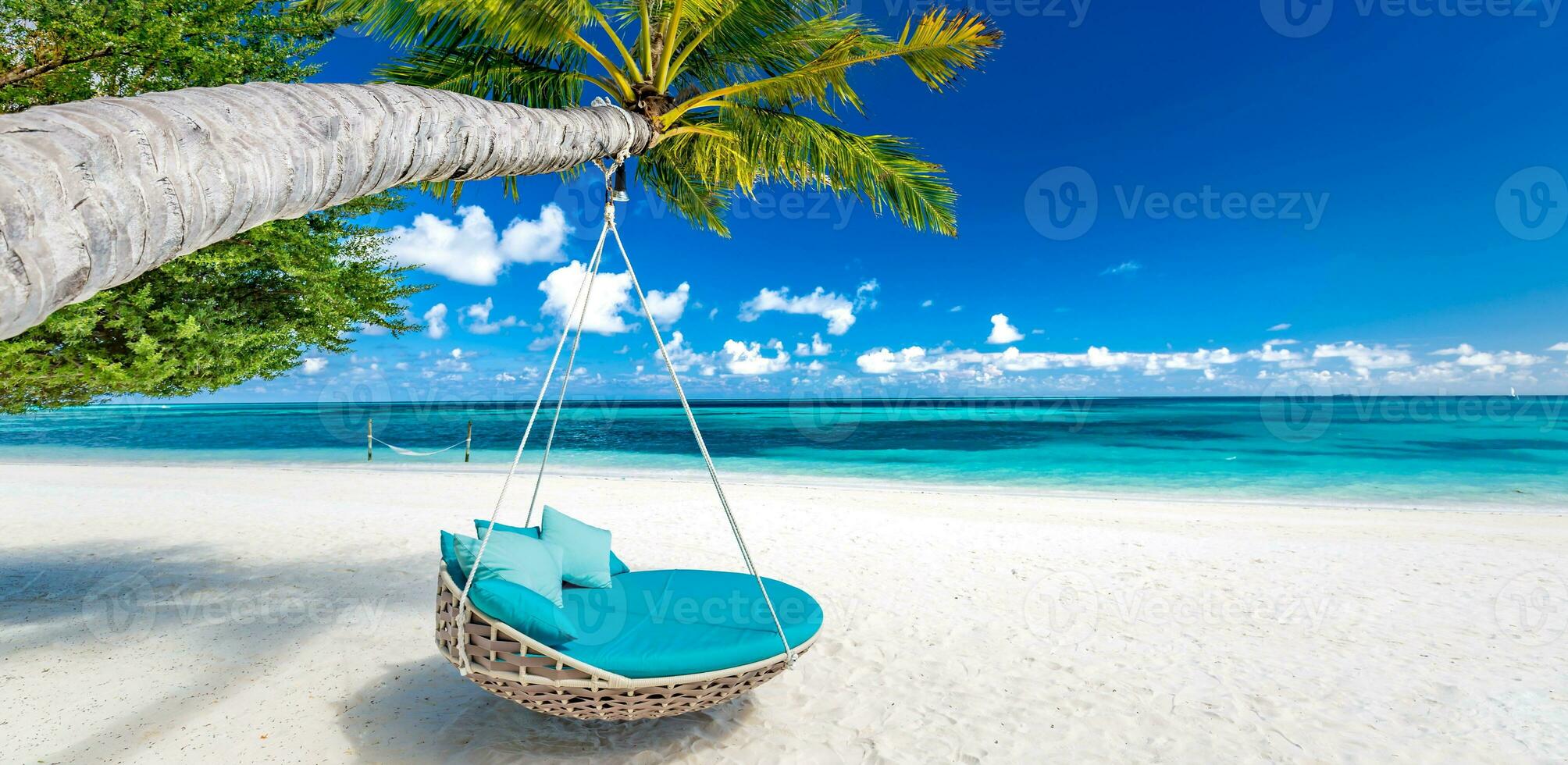 Tropical beach background summer relax landscape. Romantic beach swing hammock over white sand calm sea. Amazing best vacation and summer holiday. Luxury travel tranquil leisure lifestyle photo