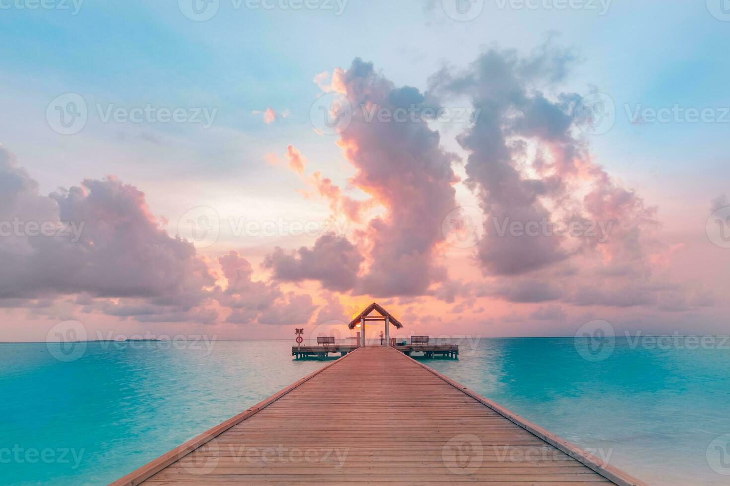 Amazing sunset panorama at Maldives. Luxury resort villas seascape with soft led lights under colorful sky. Beautiful twilight sky and colorful clouds. Beautiful beach background for vacation holiday photo