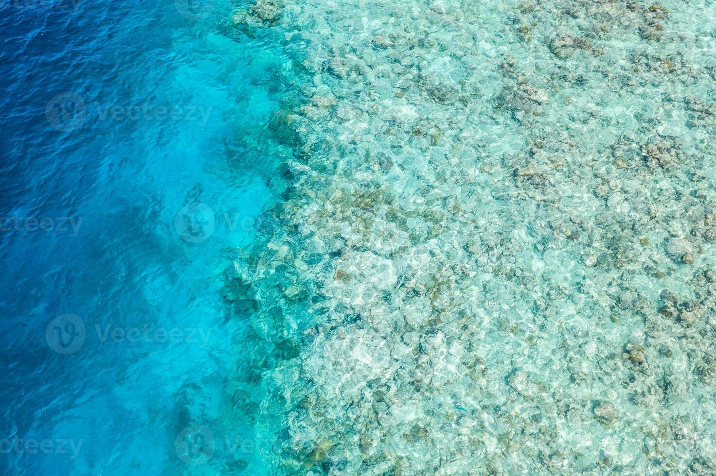 Shades of blue. Beautiful coral reef in Maldives island, aerial landscape, shallow sea water as lagoon. Amazing exotic nature texture underwater and ocean surface. photo