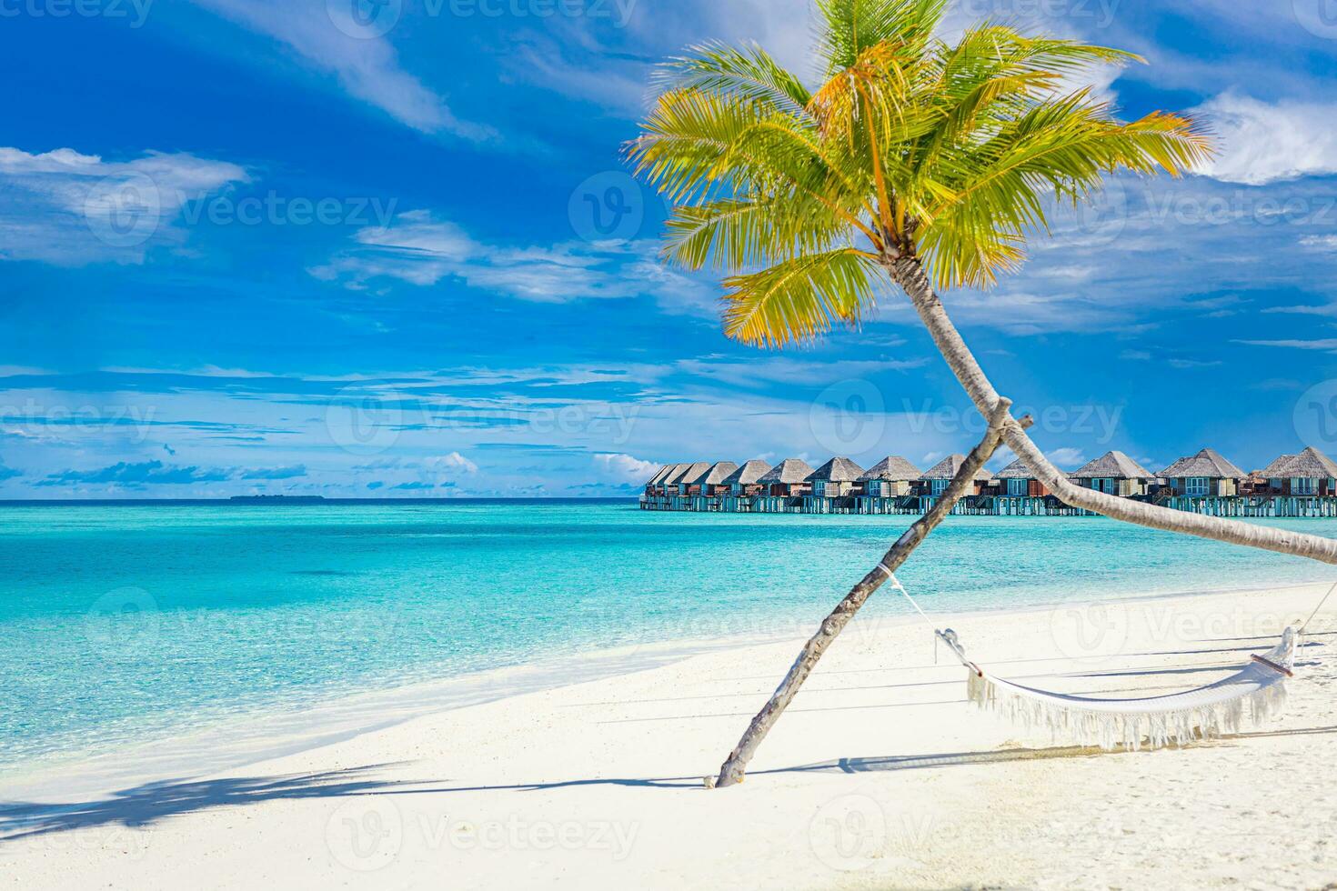 Tropical beach background as summer landscape with beach swing or hammock and white sand and calm sea for beach banner. Perfect beach scene vacation and summer holiday concept. Boost up color process photo