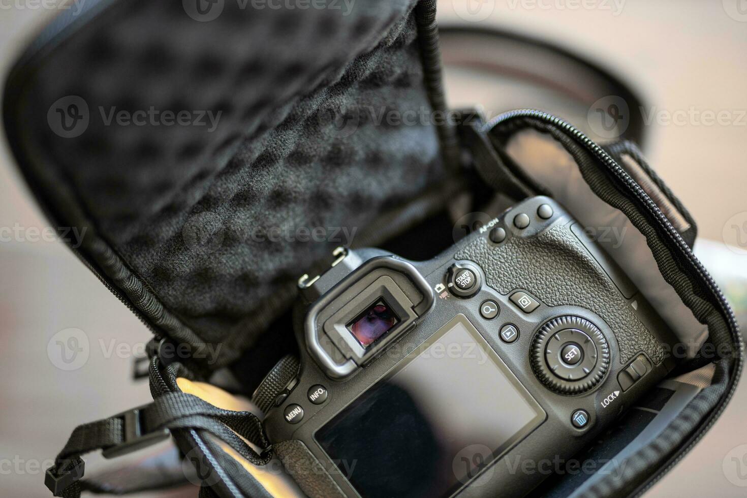 Black bag with dslr camera. Abstract photography background, photographer equipment in bag photo