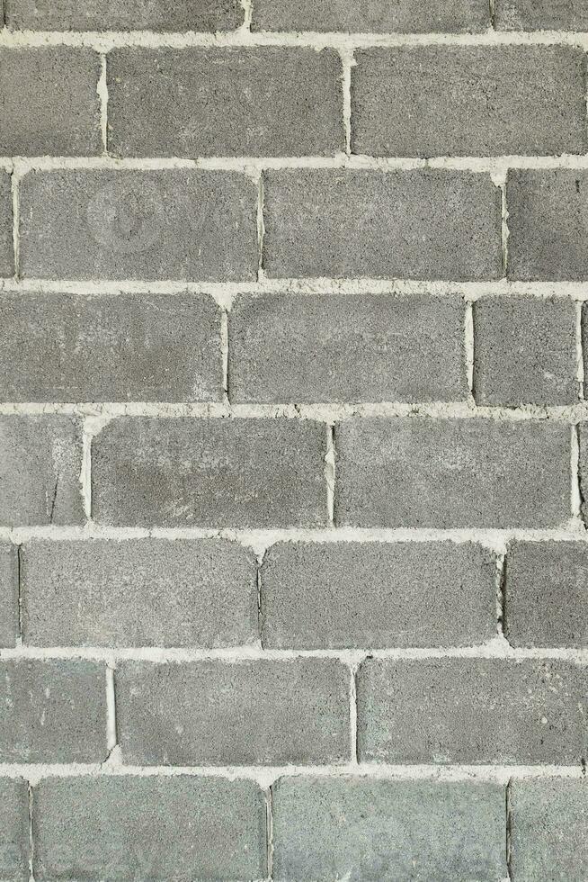 Brick blocks lined up to form a wall. photo