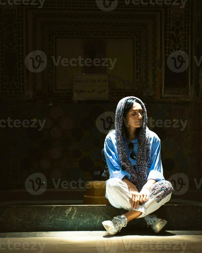 Kashan, Iran, 2022 - Tourist pose with Interior and art in bathing hall garmkhaneh at Sultan Amir Ahmad Bathhouse. Persian public bathhouse. Kashan is a popular tourist destination photo