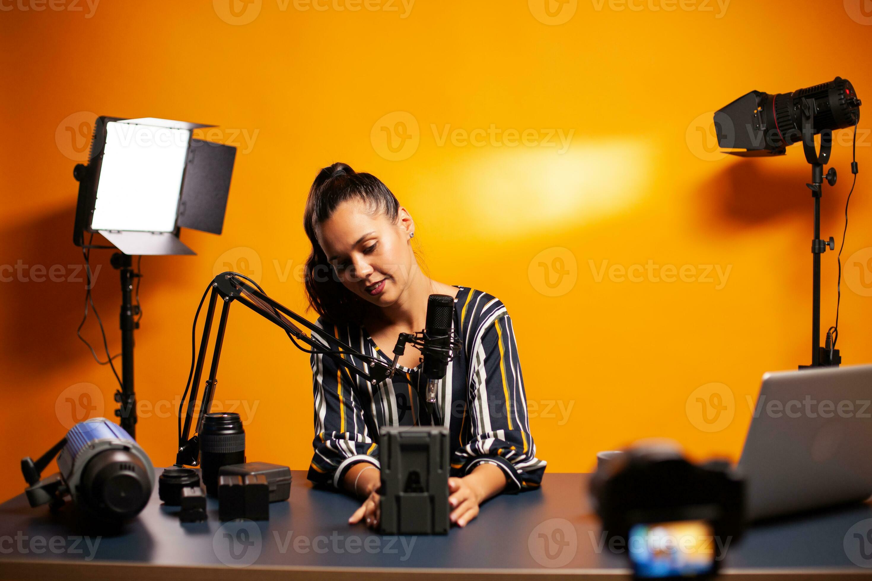 Talking about rechargeable battery while recording video review.  Professional videography gear review by content creator new media star  influencer on social media. 35343362 Stock Photo at Vecteezy