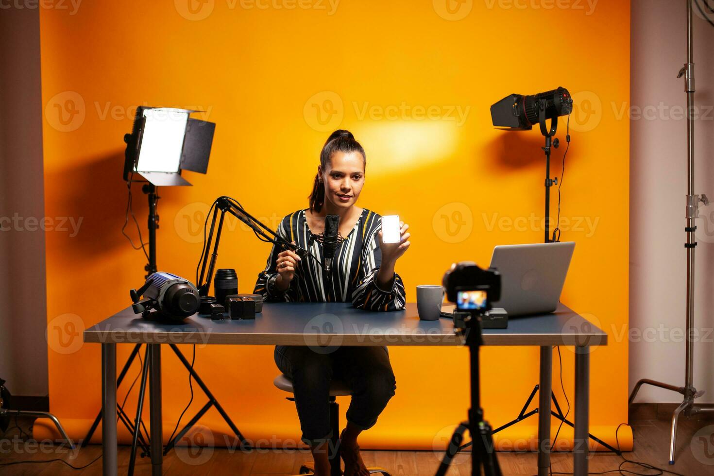 Famous videographer recording podcast about the use of mini led in home studio. Video blogger recording a vlog with technology product equipment use in videography and photography. photo