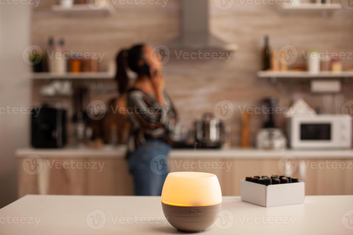 Diffusion of essential oils in kitchen for relaxation. Aroma health essence, welness aromatherapy home spa fragrance tranquil theraphy, therapeutic steam, mental health treatment. photo
