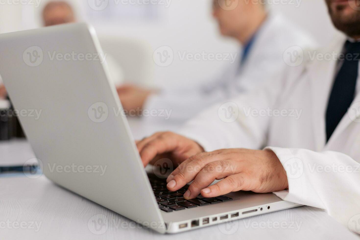 Closeup of physician practitioner doctor hands analyzing disease diagnosis examination typing sickness treatment working in meeting room. Therapist man prescribing healthcare pills medication photo