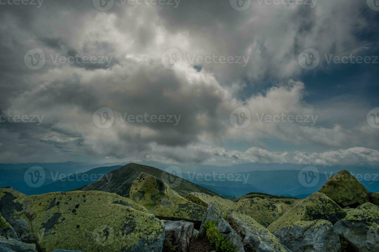 Beautiful clouds over mountains and rocks. View from the top of the mountain photo