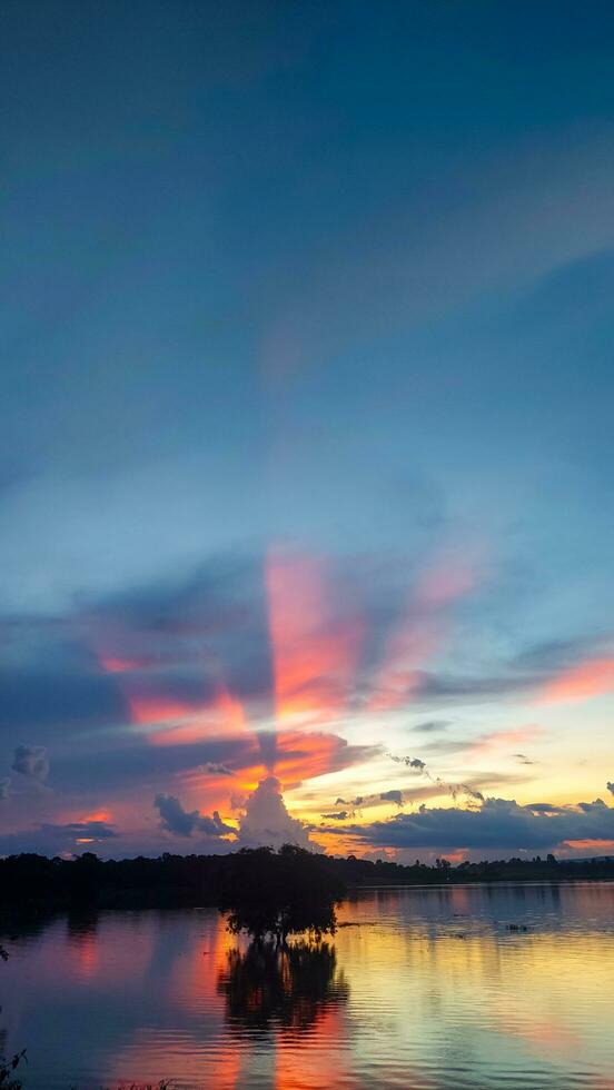 Sunset reflection and clouds in the reservoir photo