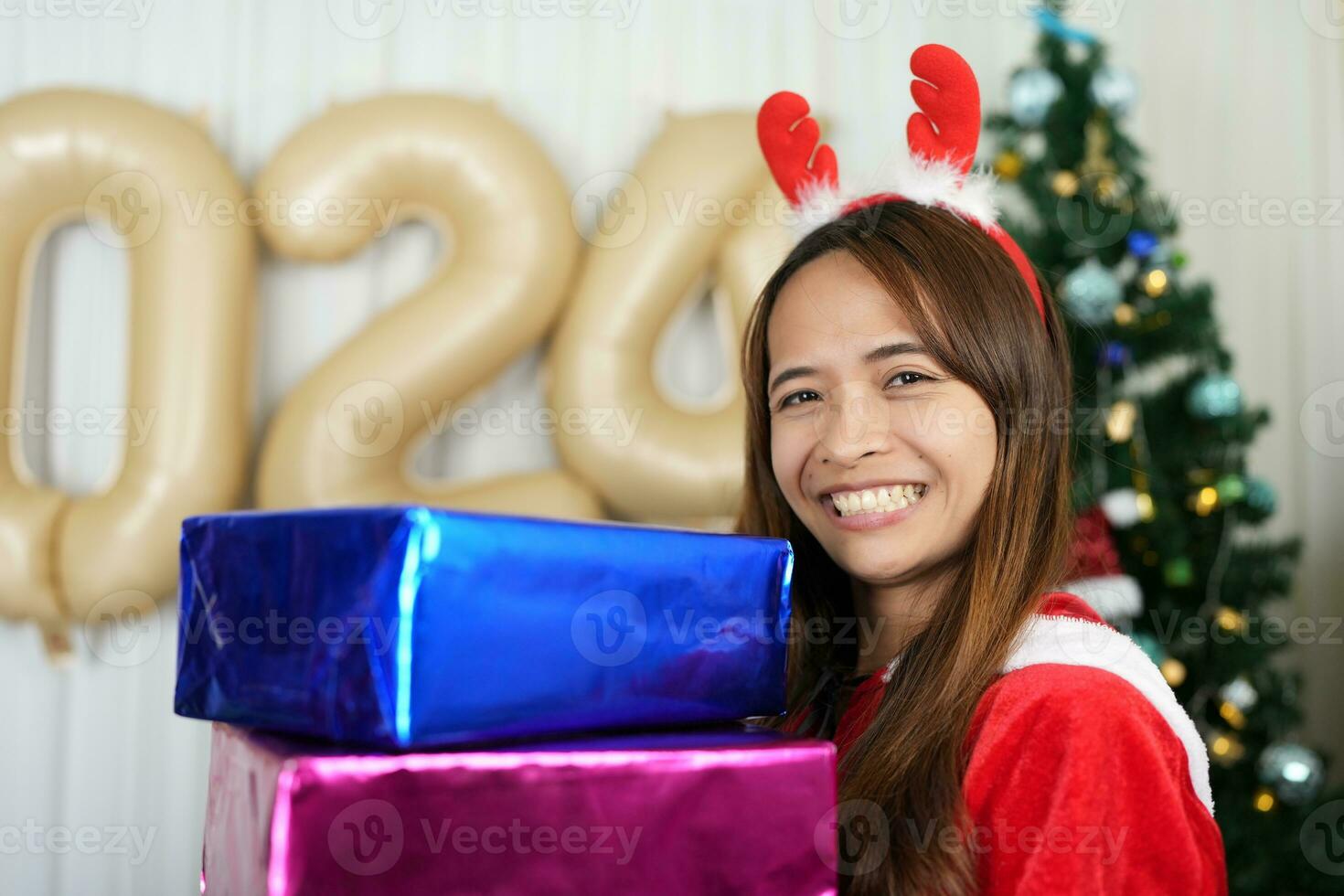 Merry Christmas 2024 concept Asian women are happy and delighted to receive Christmas gifts. photo