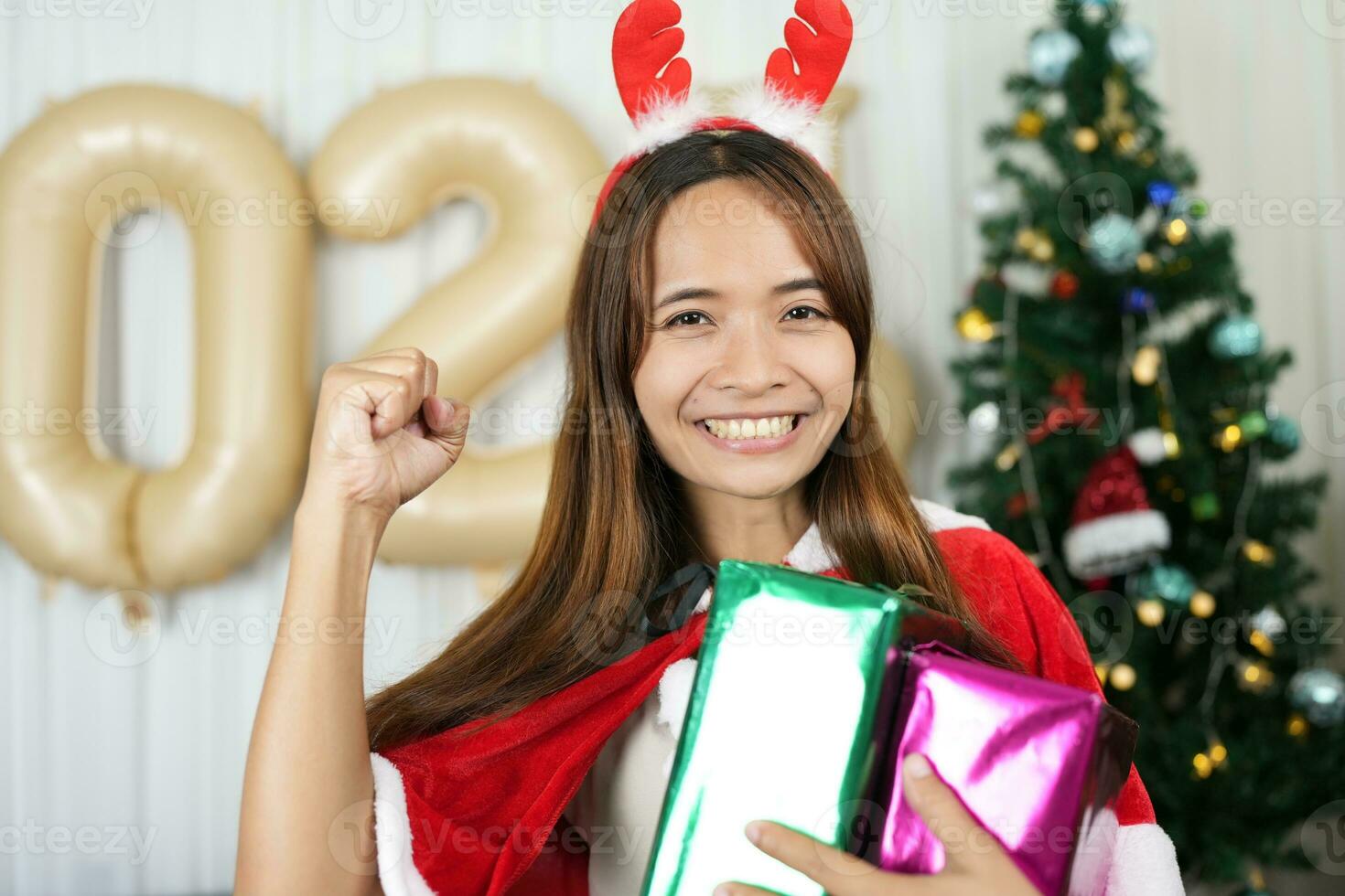 Merry Christmas 2024 concept Asian women are happy and delighted to receive Christmas gifts. photo