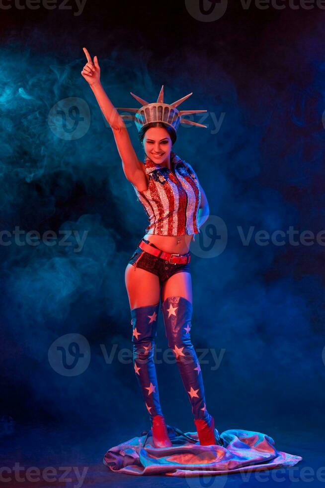 Young woman in stage costume of striptease dancer posing photo