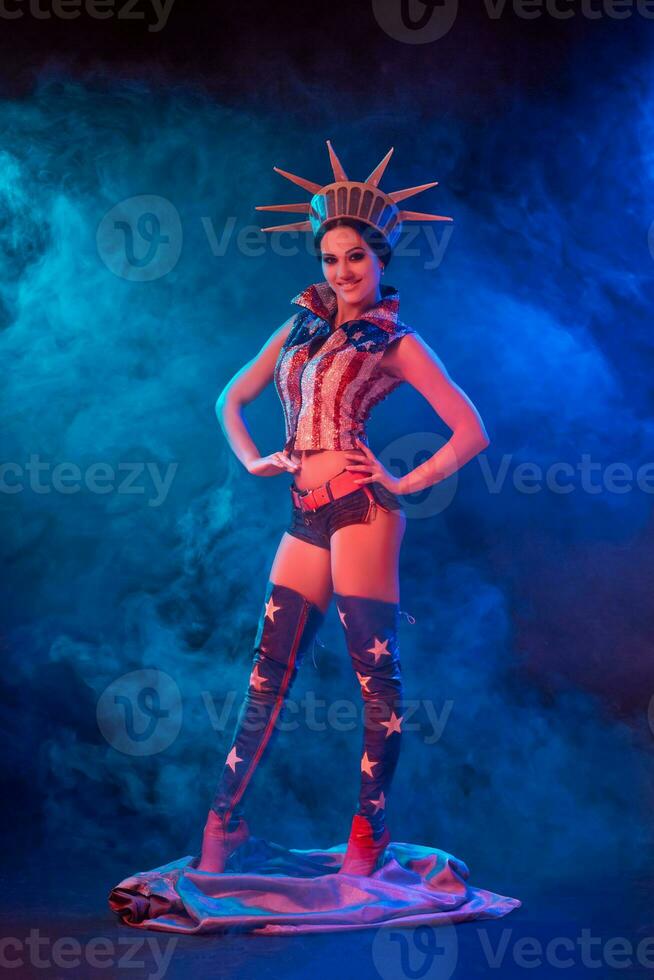 Young woman in stage costume of striptease dancer posing photo