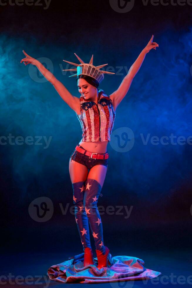 Young woman in stage costume of striptease dancer posing photo