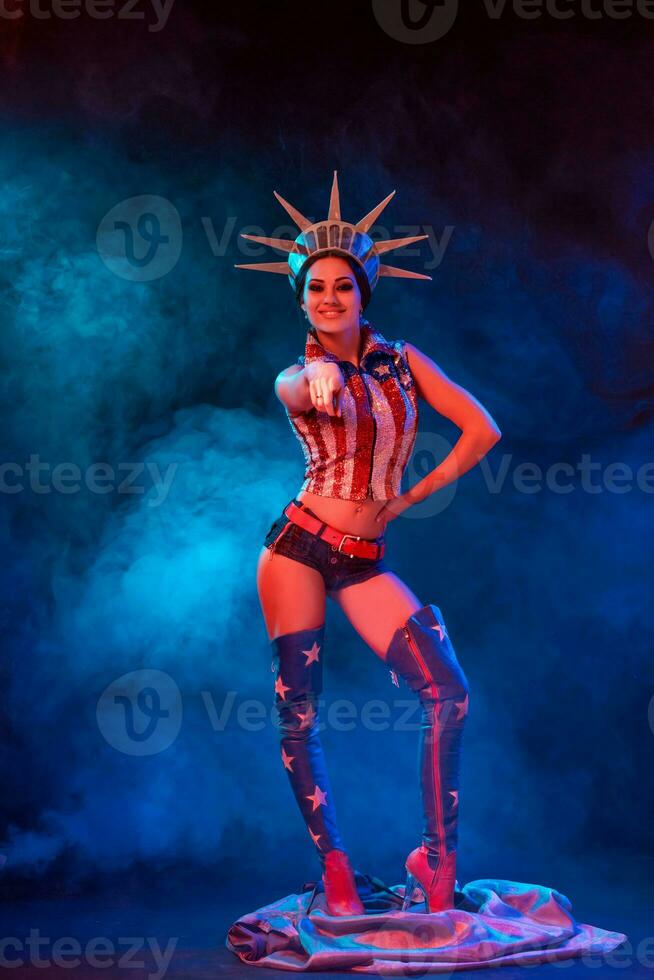 Young woman in stage costume of striptease dancer posing photo