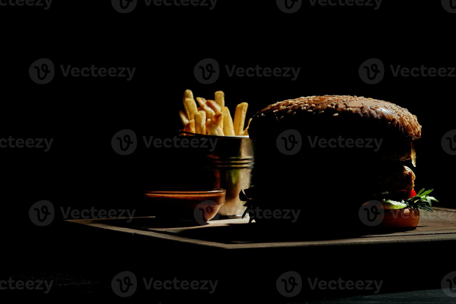 Silhouette of hamburger with french fries and sauce photo