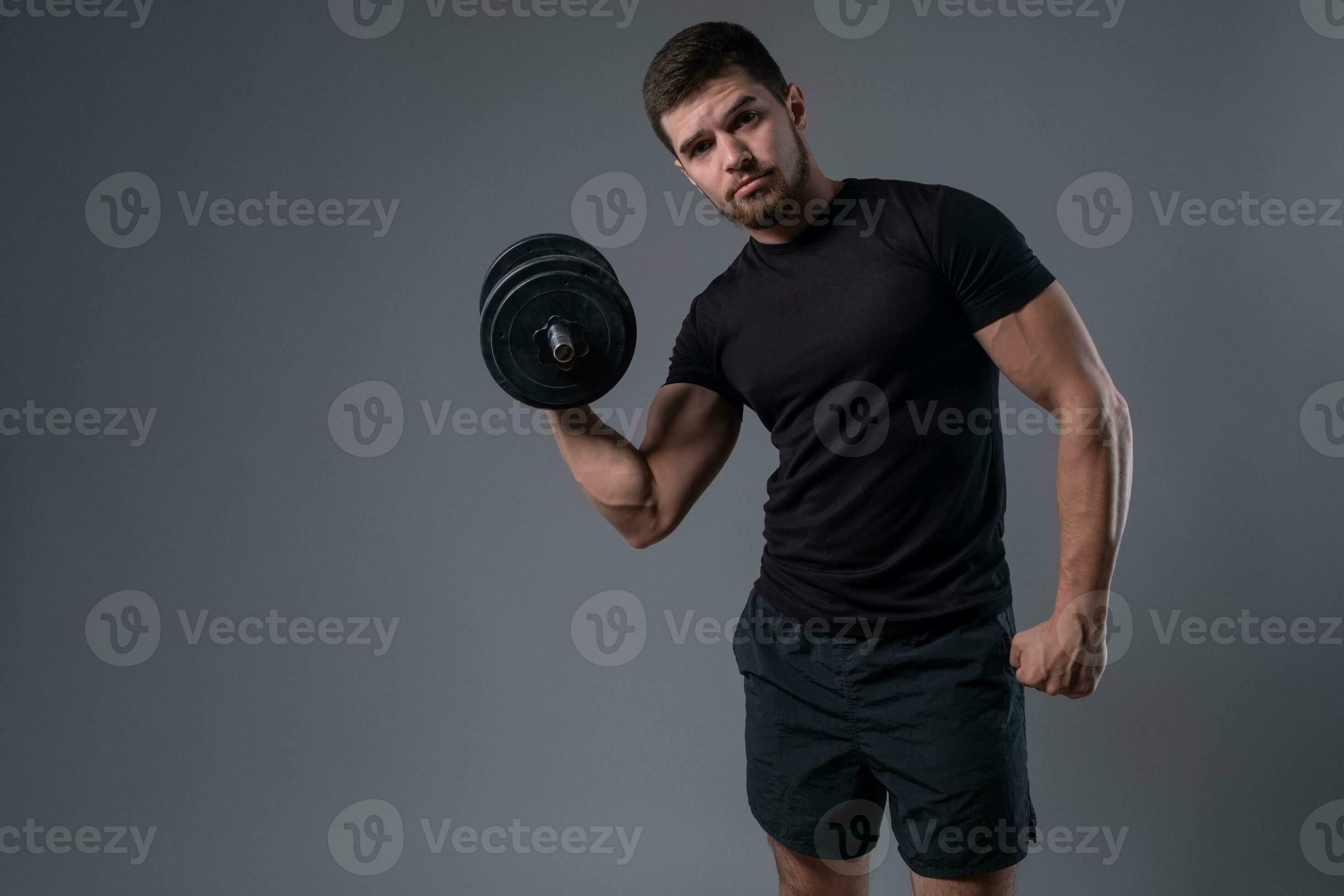 Young man doing set of arm exercises with dumbbells 35354878 Stock Photo at Vecteezy