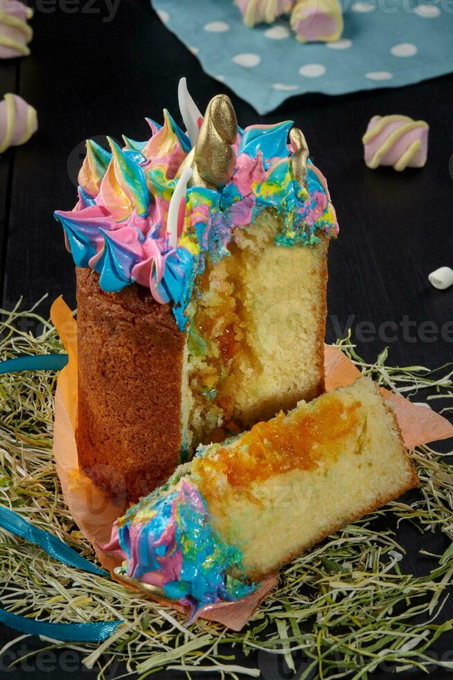 Sliced Easter cake with whipped egg whites in shape of unicorn photo