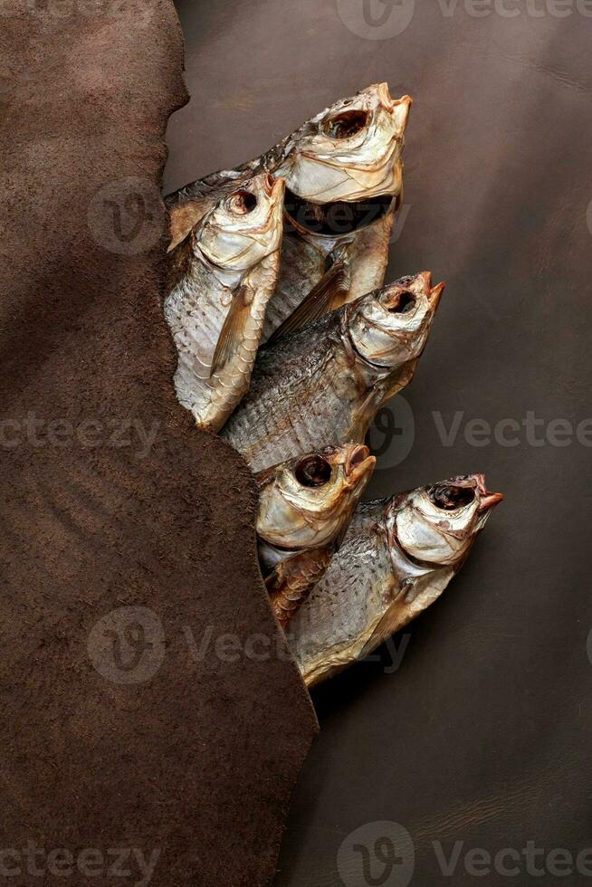 Salted sun-dried roach covered with genuine leather flap photo