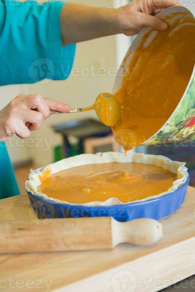 Unrecognizable woman cooking pumpkin cake photo