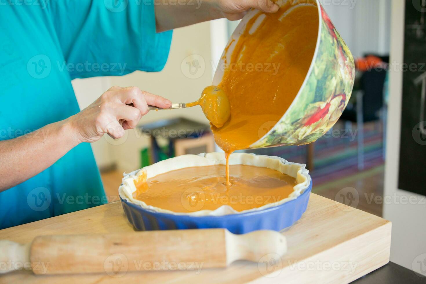 Unrecognizable woman cooking pumpkin cake photo