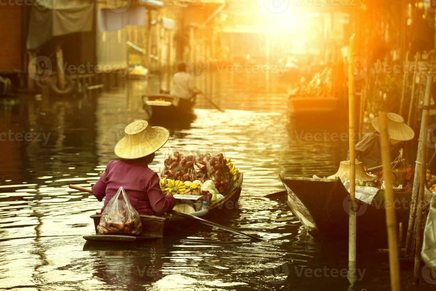 thai fruit seller sailing wooden boat in thailand tradition floating market photo