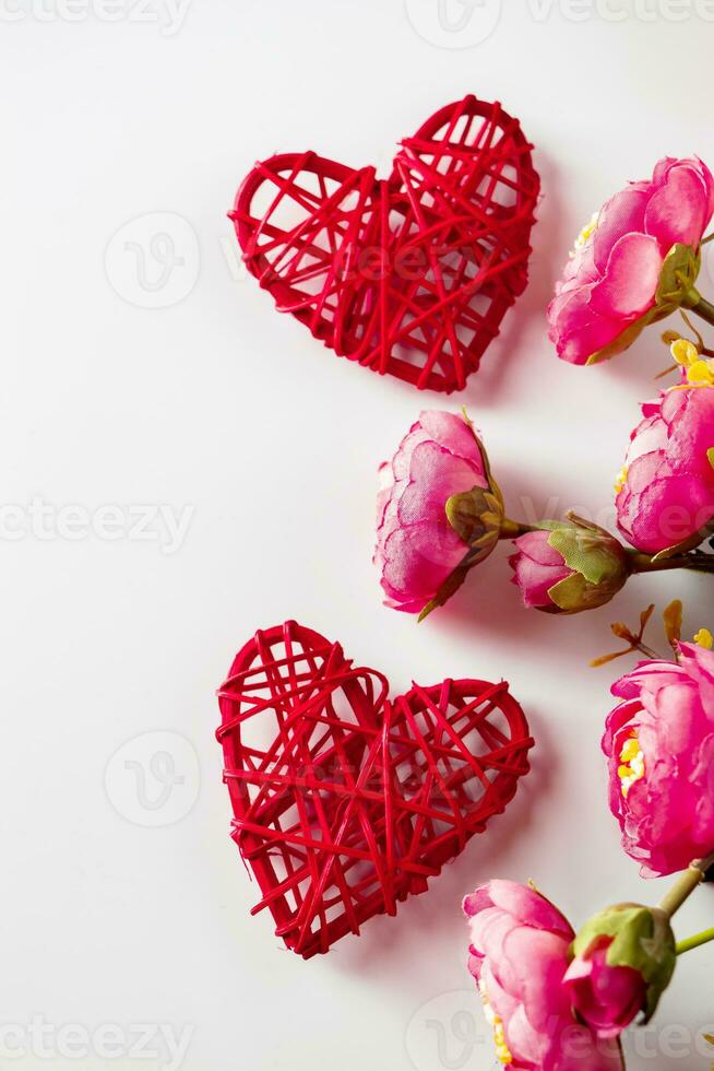 Flowers and red hearts on a white background for Valentine's Day photo