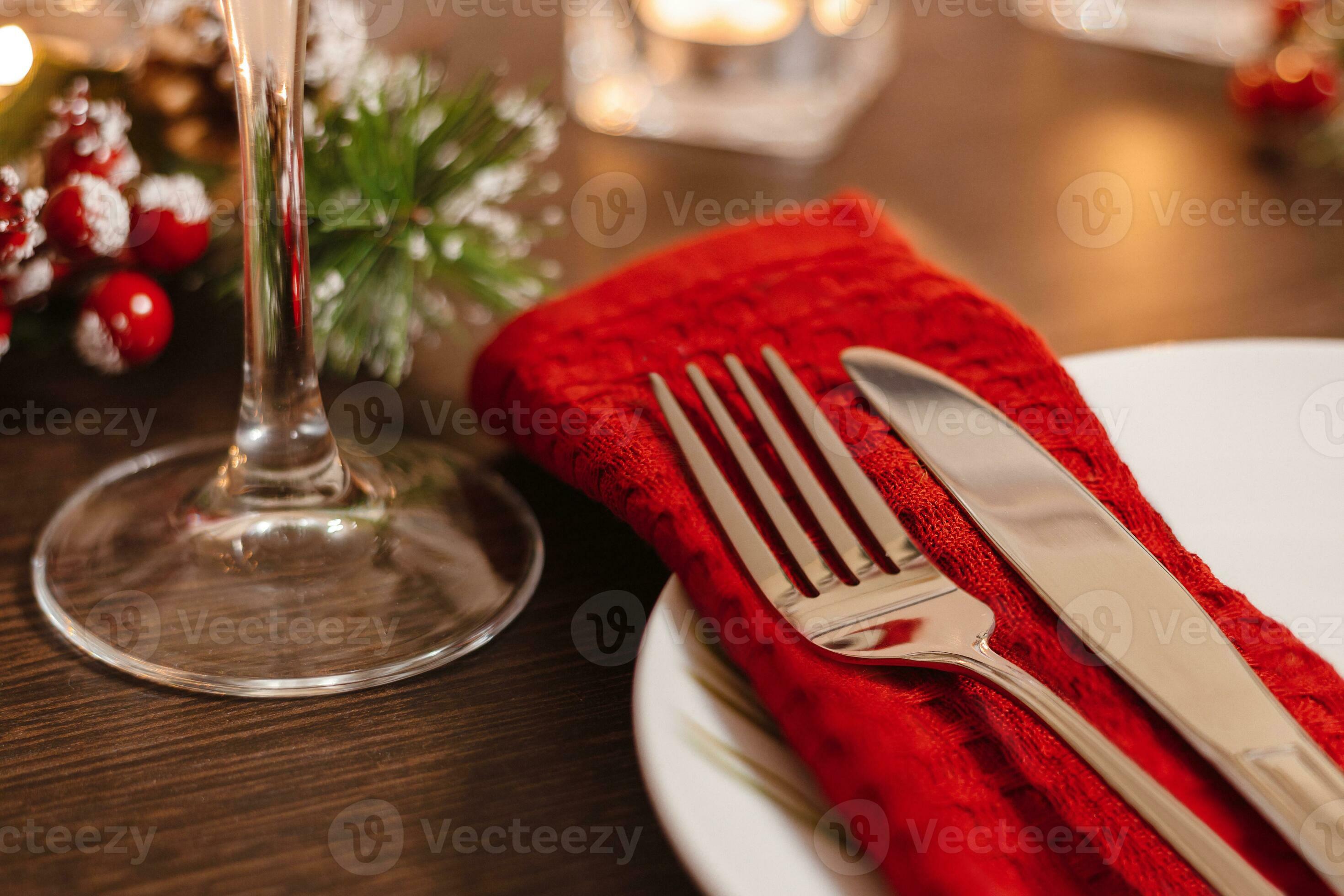 Christmas table setting. Plate and cutlery on napkin. Preparing for