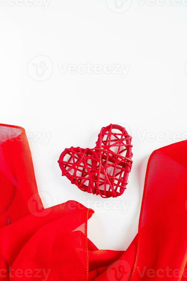 Red hearts and silk ribbon on a white background photo